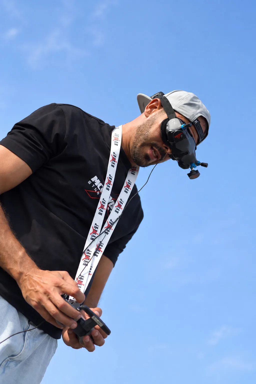 Close-up of an FPV pilot working the controller mid-flight