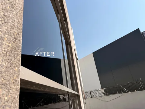 Exterior glass façade after cleaning, with the original AFTER label