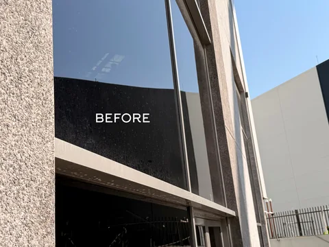 Exterior glass façade before cleaning, with the original BEFORE label