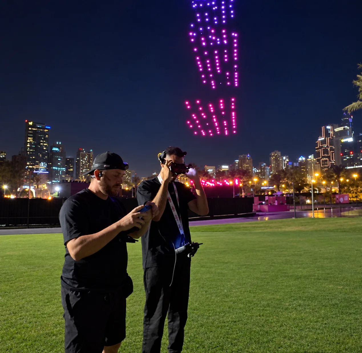 Drone filming crew working through a night-time light show