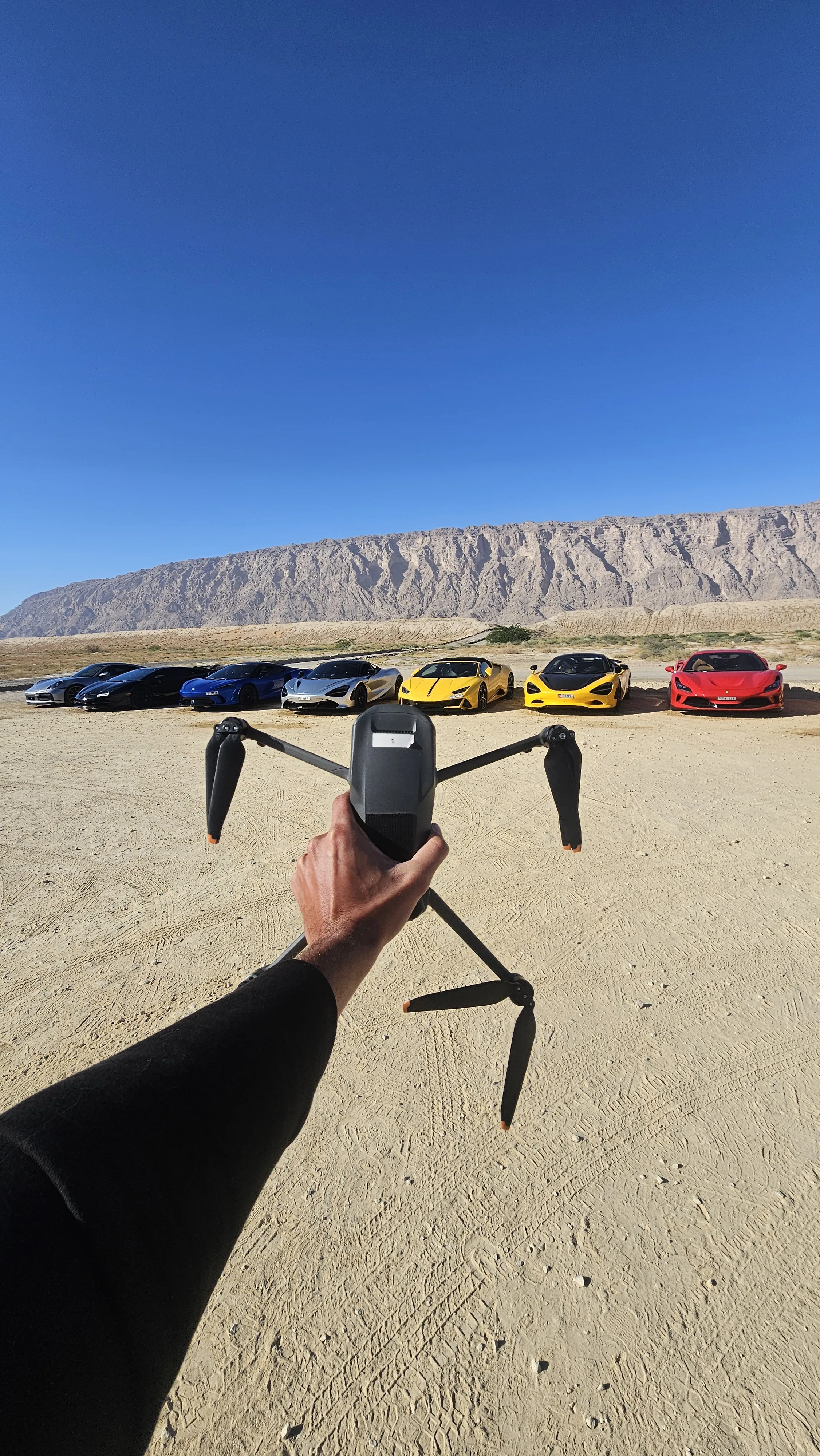 Drone prepared beside a vehicle at a filming location