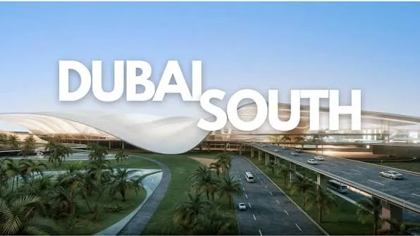 Large Dubai South lettering overlays a view of roads and landscaped development infrastructure