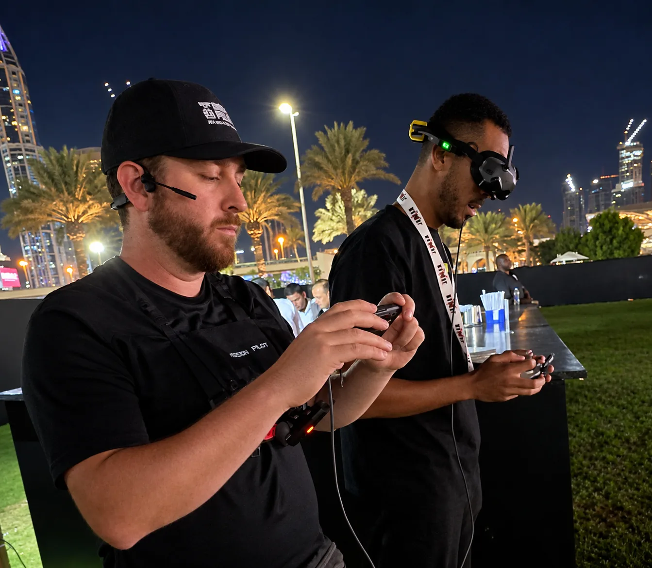 FPV crew operating controllers together during a night shoot