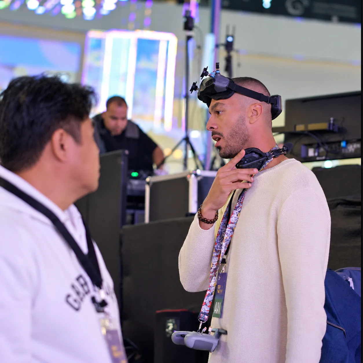 FPV pilot coordinating a flight inside an indoor event space