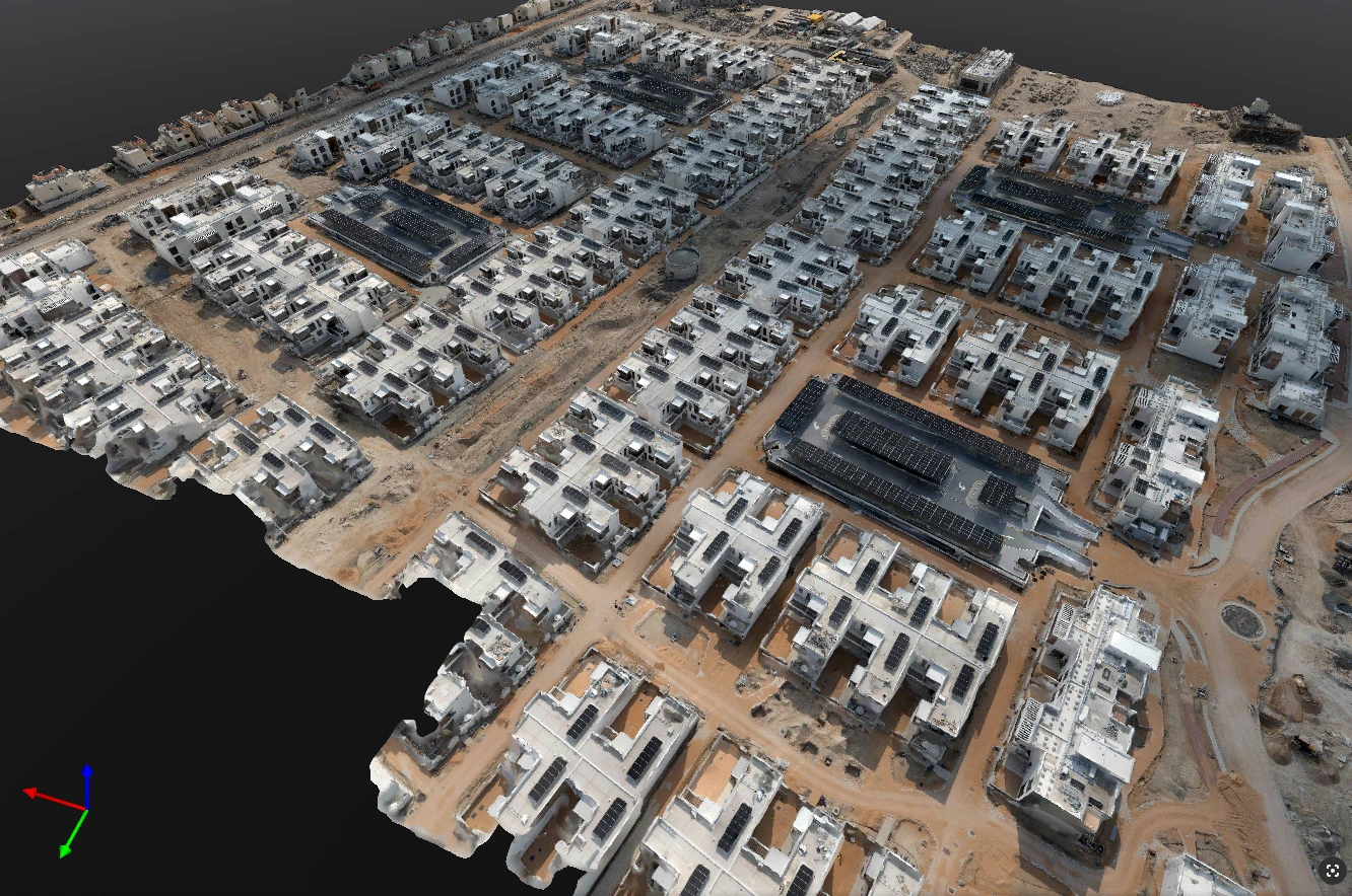 An oblique textured 3D model shows rows of residential buildings, access roads and construction areas