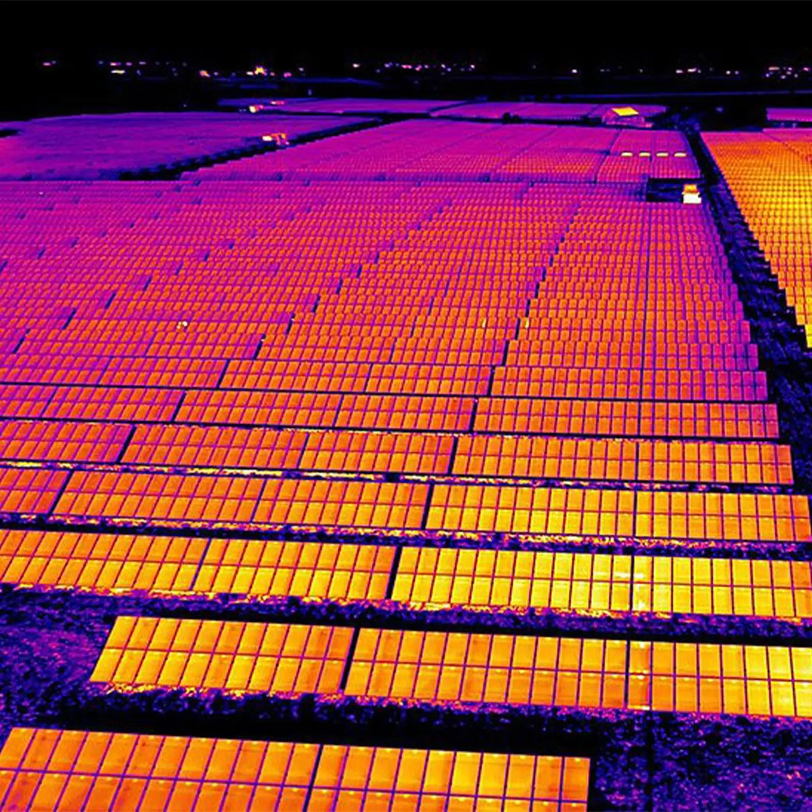 A false-color thermal image shows rows of rooftop solar panels with visible temperature variation